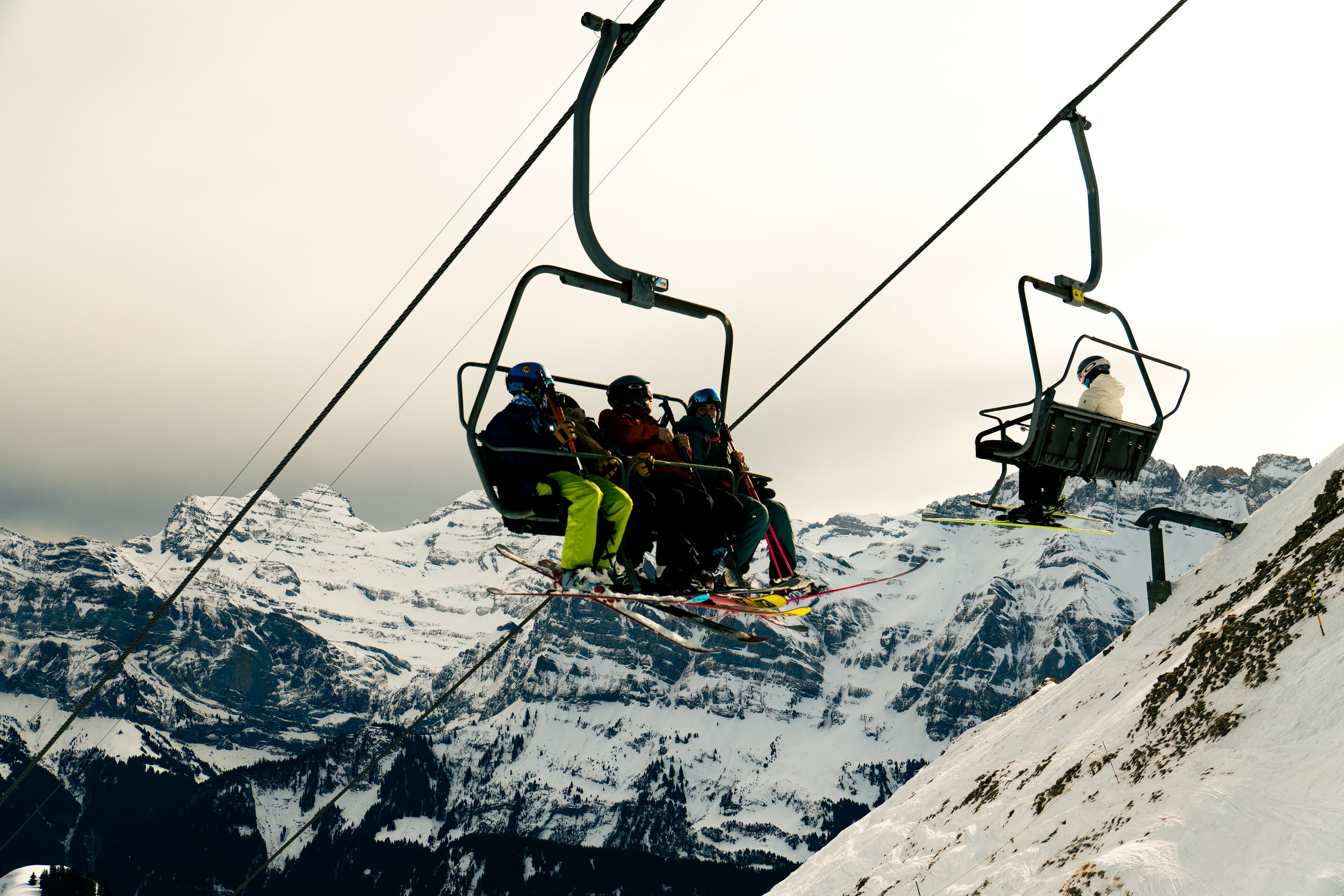 Skiers riding a chairlift toward the mountain